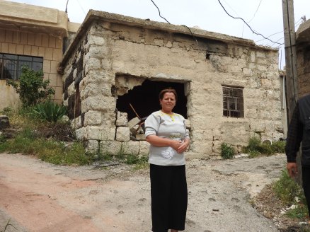 Now unemployed Hadar resident outside her former food and dairy shop destroyed in terrorist shelling in September 2017